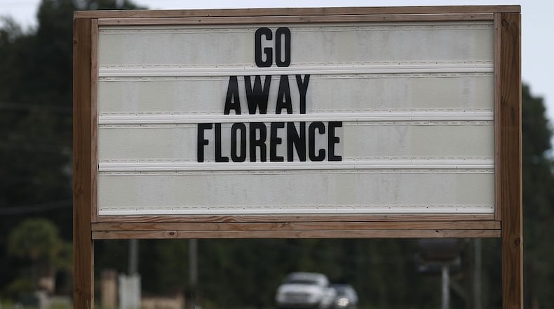 A sign reads "Go Away Florence" ahead of the arrival of Hurricane Florence  to the Carolinas. Several birds were blown off a vehicle due to high winds Thursday,