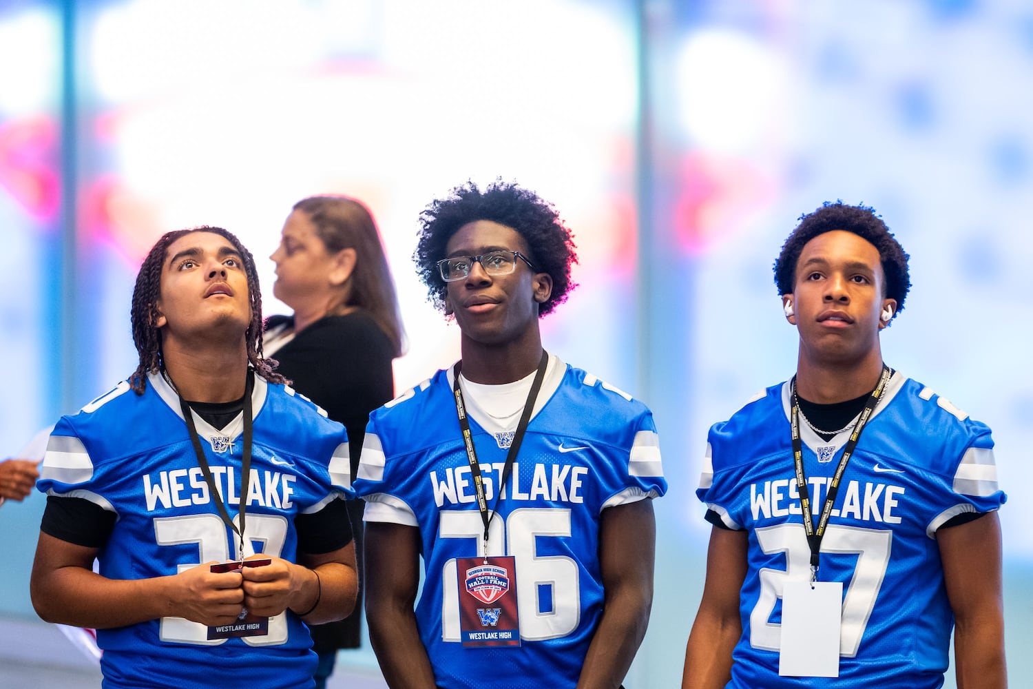 Westlake High School football players J.L. Vance (from left), Timothy Glover, and Langston Smith examine the lobby of the College Football Hall of Fame in Atlanta during the Georgia High School Football Hall of Fame induction ceremony Saturday, Oct. 25, 2025. (Daniel Varnado for the AJC