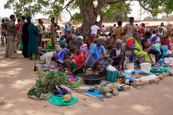 FILE - Women sell their goods at Nzara open market in Nzara, South Sudan on Saturday, Feb. 15, 2025. (AP Photo/Brian Inganga, File)