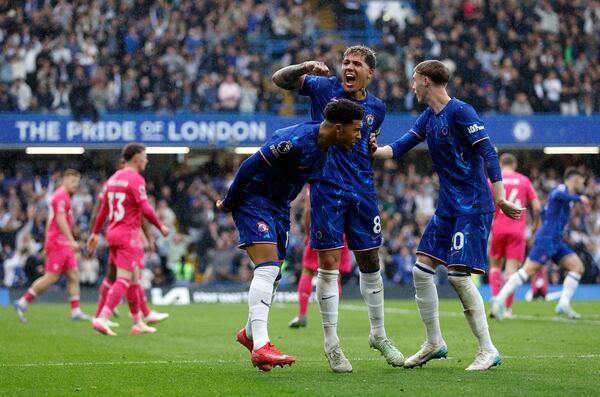 Chelsea's Jadon Sancho, left, celebrates with Enzo Fernandez, centre, and Cole Palmer after scoring their side's second goal of the game during the English Premier League soccer match between Chelsea and Ipswich Town at Stamford Bridge in London, Sunday April 13, 2025. (Nigel French/PA via AP)
