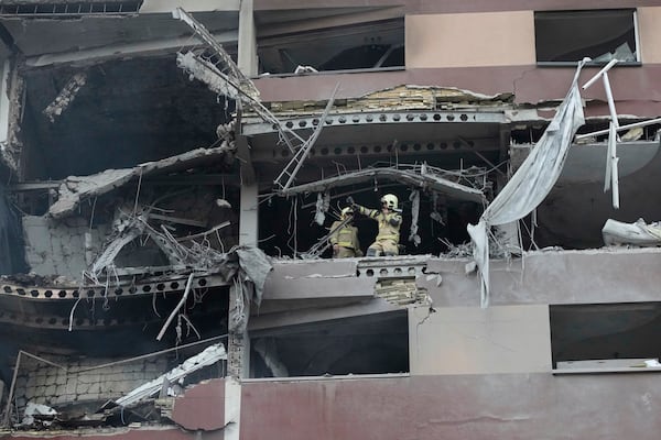 Firefighters work the scene of an explosion at a residence compound in northern Tehran, Iran, Friday, June 13, 2025. (AP Photo/Vahid Salemi)