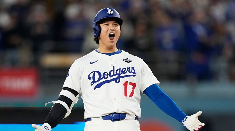 Los Angeles Dodgers' Shohei Ohtani celebrates hit RBI-Double against the Toronto Blue Jays during the fifth inning in Game 3 of baseball's World Series, Monday, Oct. 27, 2025, in Los Angeles. (AP Photo/Brynn Anderson)