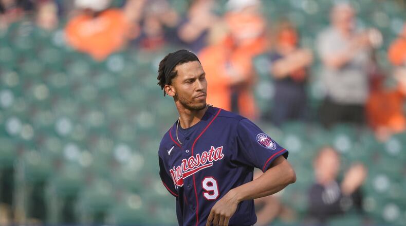 Minnesota Twins' Andrelton Simmons walks back to the dugout after striking out to end the tenth inning of a baseball game against the Detroit Tigers, Tuesday, April 6, 2021, in Detroit. (AP Photo/Carlos Osorio)