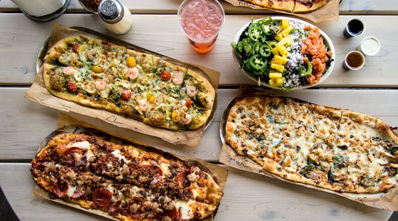 Slim and Husky's signature artisan pizzas and a Hotboy salad. Photo credit- Mia Yakel.