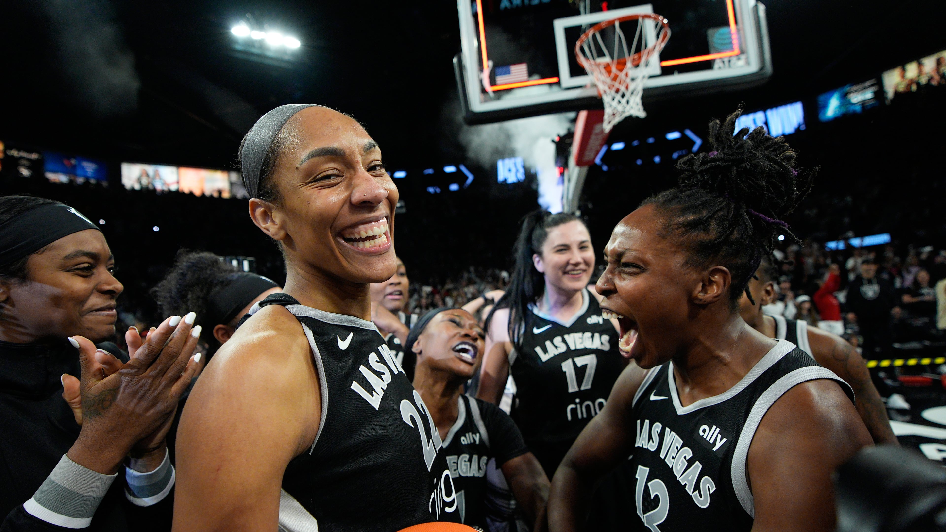 Las Vegas Aces center A'ja Wilson (22) and Las Vegas Aces guard Chelsea Gray (12) celebrate after the Las Vegas Aces defeated the Indiana Fever in Game 5 of a WNBA basketball playoff semifinals series Tuesday, Sept. 30, 2025, in Las Vegas. (AP Photo/John Locher)