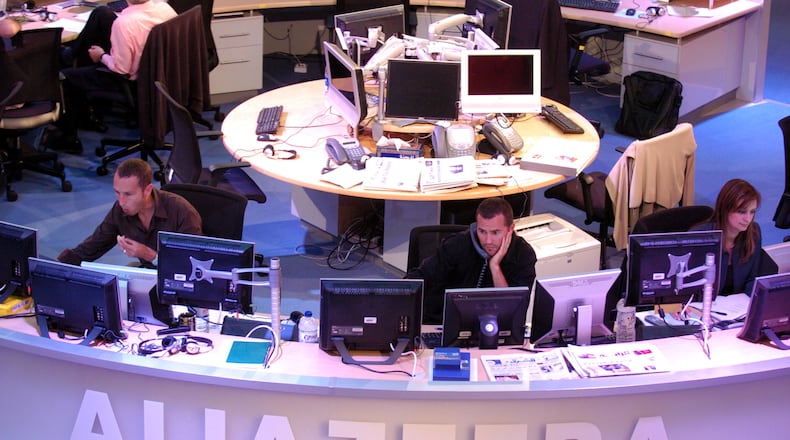 Al Jazeera English channel staff prepare for the first broadcast in Doha news room in Qatar on Tuesday, Nov. 14, 2006. AP Photo/ Hamid Jalaudin