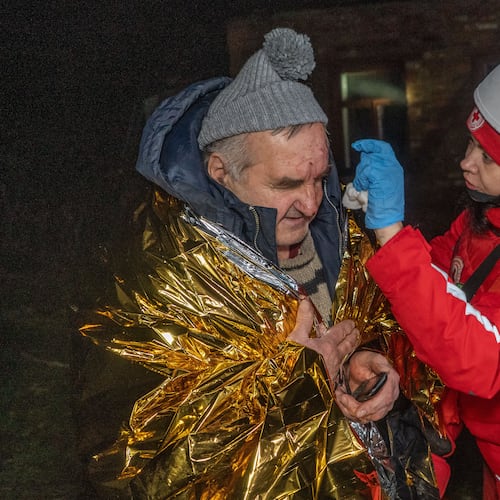 A paramedic gives first aid to a resident who was injured in a Russian airstrike in Kharkiv, Ukraine, late Sunday, Nov. 23, 2025. (AP Photo/Andrii Marienko)