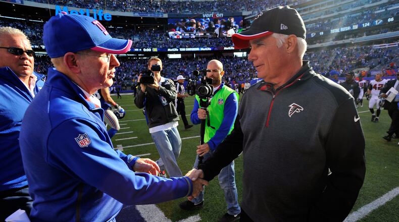 EAST RUTHERFORD, NJ - OCTOBER 05: Head coach Tom Coughlin of the New York Giants talks with head coach Mike Smith of the Atlanta Falcons after their game at MetLife Stadium on October 5, 2014 in East Rutherford, New Jersey. The New York Giants defeated the Atlanta Falcons 30 - 20. (Photo by Alex Goodlett/Getty Images) Tom Coughlin's and Mike Smith's teams are going in different directions in the NFC. (Alex Goodlett/Getty Images)