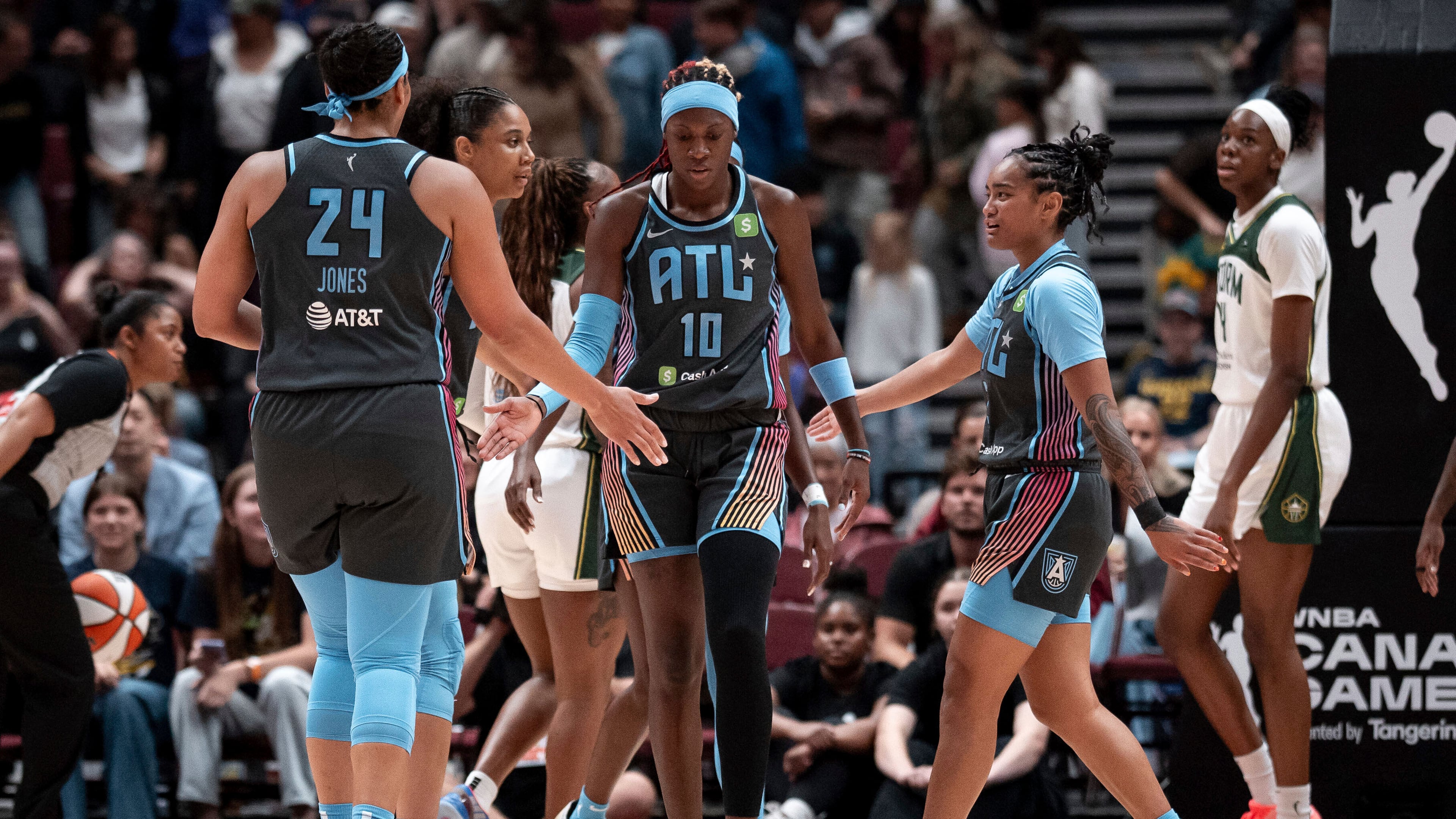 Atlanta Dream's Rhyne Howard (10) celebrates with teammates after scoring against the Seattle Storm during the first half of a WNBA basketball game in Vancouver, British Columbia, on Friday, Aug. 15, 2025. (Ethan Cairns/The Canadian Press via AP)