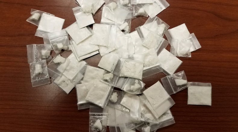 More than 60 baggies of crack and powder cocaine were recovered by authorities after a man allegedly threw them out of a window during a traffic stop in Douglas County.