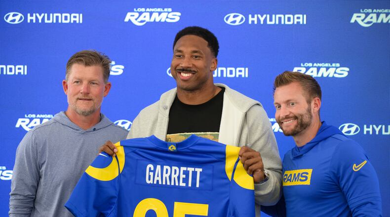 From left, Los Angeles Rams general manager Les Snead, left, defensive end Myles Garrett, and head coach Sean McVay pose for a photo during a press conference following the NFL football team's practice, Tuesday, June 2, 2026, in Woodland Hills, Calif. (AP Photo/Kyusung Gong)