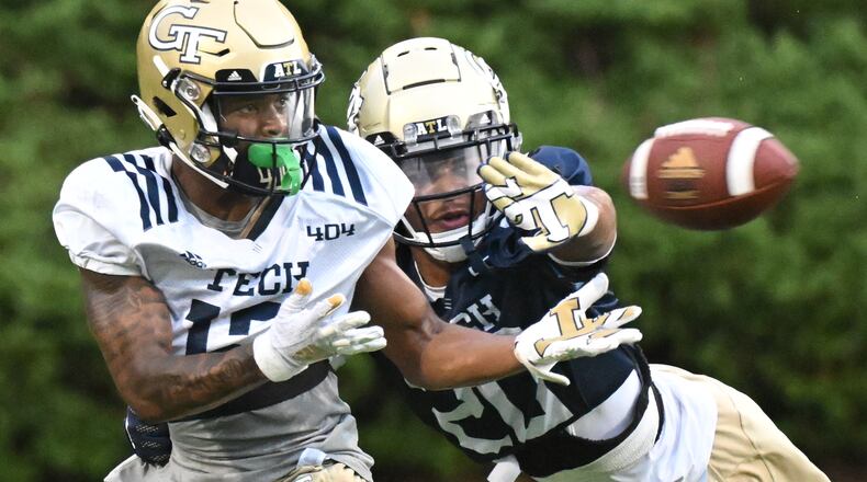 Georgia Tech wide receiver Malik Rutherford makes a catch under pressure from Georgia Tech defensive back LaMiles Brooks during the first football practice of the season Friday in Atlanta. (Hyosub Shin / Hyosub.Shin@ajc.com)