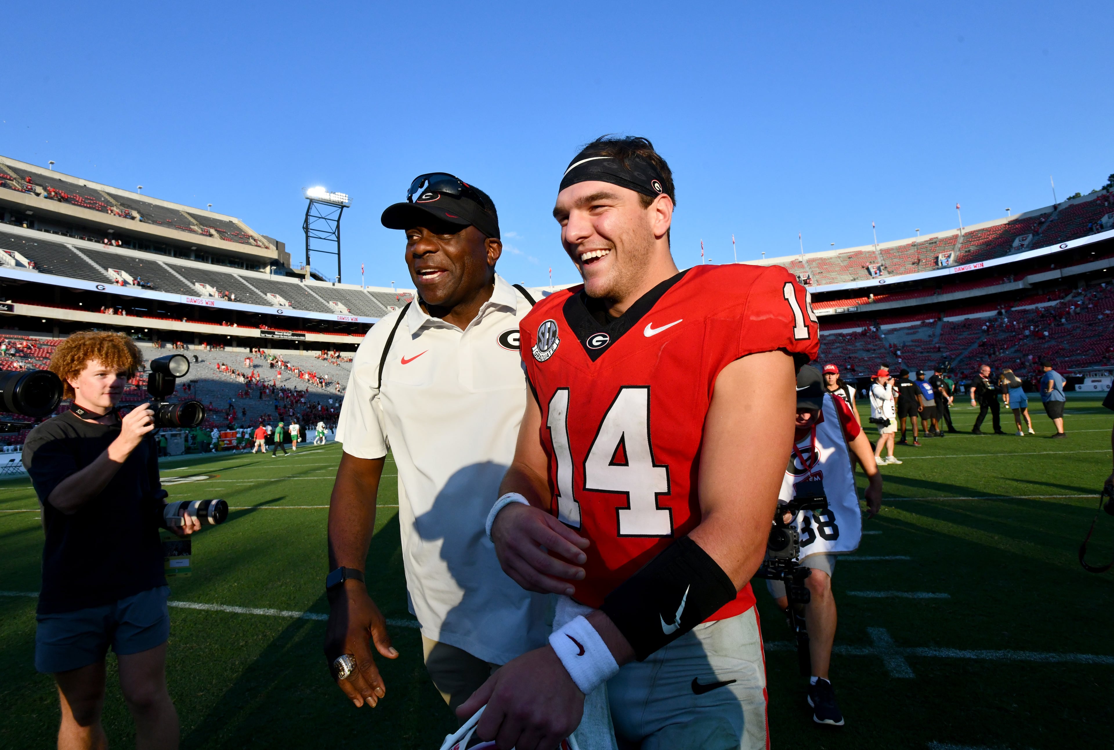 Georgia quarterback Gunner Stockton (14) leaves with Bryant Gantt, Director of Player Wellness, after Georgia beat Marshall during an NCAA football game at Sanford Stadium, Saturday, August 30, 2025, in Athens. Georgia won 45-7 overMarshall. (Hyosub Shin / AJC)