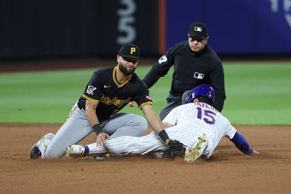 New York Mets' Tyrone Taylor (15) steals second base against Pittsburgh Pirates shortstop Isiah Kiner-Falefa, left, during the seventh inning of a baseball game Monday, May 12, 2025, in New York. (AP Photo/Pamela Smith)