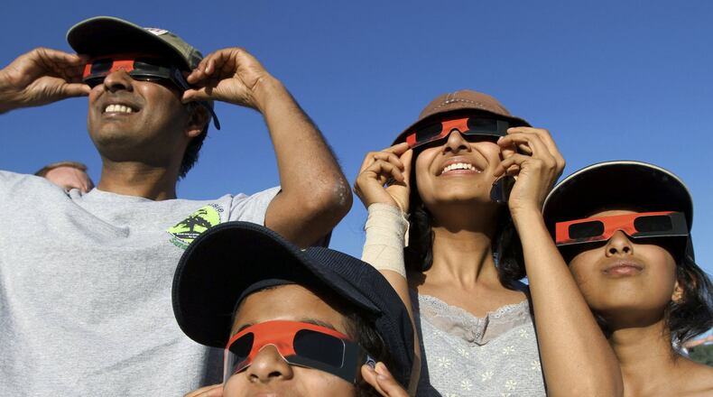 People observe a 2012 solar eclipse in Chico, California.