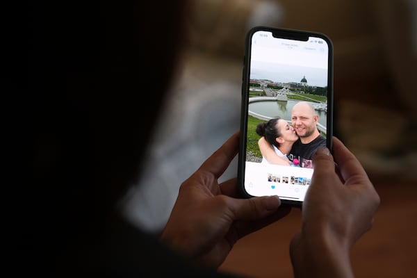 Oksana Tarasiuk holds a cell phone displaying a picture of herself, left, with her husband, Maksym Chernyak, who died in ICE custody after being held at Krome Detention Center, inside the couple's apartment in Hallandale Beach, Fla., Tuesday, April 22, 2025. (AP Photo/Rebecca Blackwell)