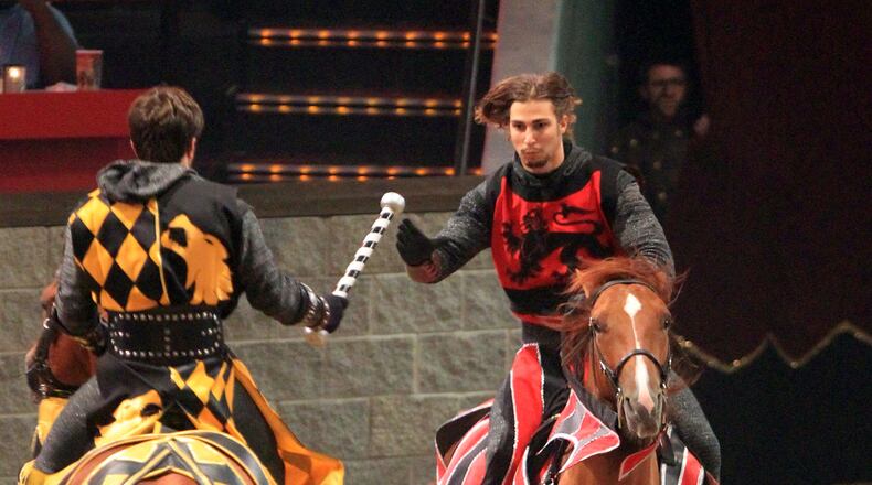 Medieval Times Red Knight Clint Mally, of Lawrenceville, 23, right, competes on his horse Peppy, a quarterhorse, during a relay race with other knights during the evening show at Discover Mills mall (currently Sugarloaf Mills mall) Saturday afternoon in Lawrenceville, Ga., July 28, 2012.