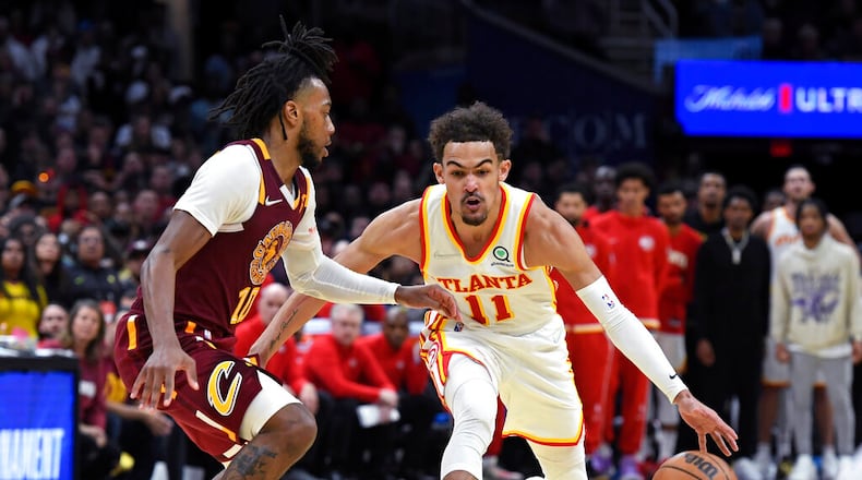 Atlanta Hawks' Trae Young (11) drives against Cleveland Cavaliers' Darius Garland (10) during the second half of an NBA play-in basketball game Friday, April 15, 2022, in Cleveland. (AP Photo/Nick Cammett)