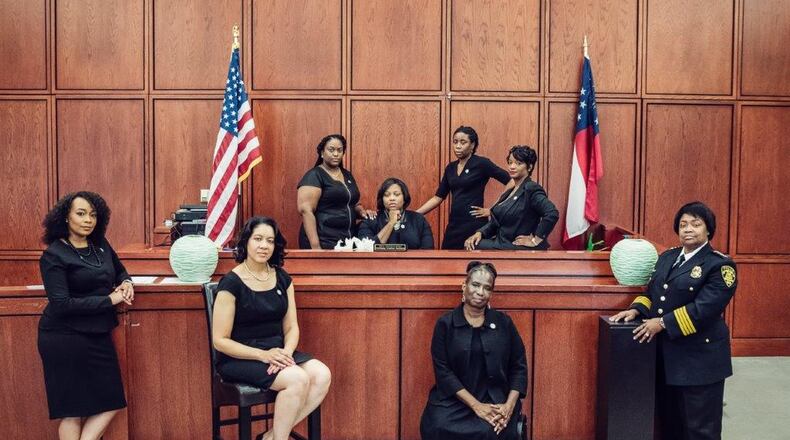 This photo went viral showing the eight African-American women who are leading the City of South Fulton’s law enforcement and municipal court system. They are, front row, left to right: City Solicitor LaDawn Jones, Court Administrator Lakesiya Cofield, Public Defender Viveca R. Famber Powell, Interim Police Chief Sheila Rogers. Back row, left to right: Clerk Kerry Stephens, Chief Judge Tiffany Carter Sellers, Clerk of Court Ramona Howard, Clerk Tiffany Kinslow. (Photo by Reginald Duncan, Cranium Creation)