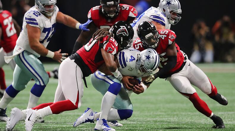 Falcons defensive end Adrian Clayborn collects one of his six sacks on Cowboys quarterback Dak Prescott Sunday. (Curtis Compton/ccompton@ajc.com)