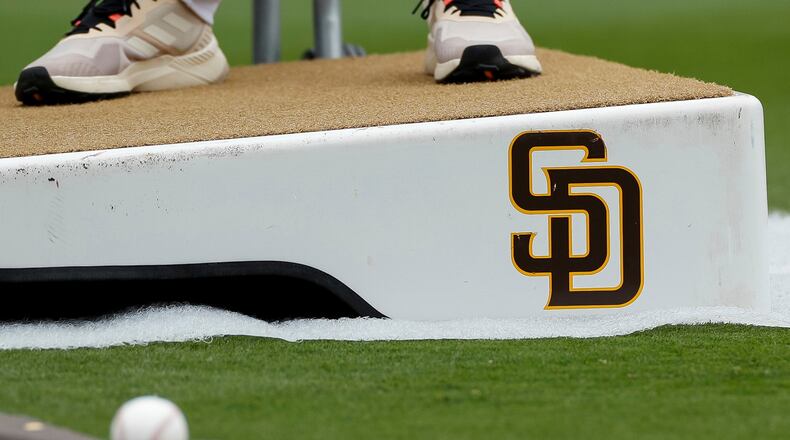 FILE - Detailed view of a San Diego Padres logo on a pitching mound during batting practice prior to a baseball game between the Padres and Boston Red Sox, May 20, 2023, in San Diego. (AP Photo/Brandon Sloter, File)