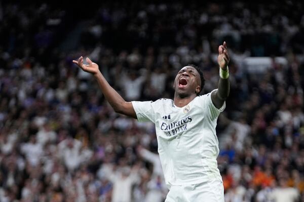 Real Madrid's Vinicius Junior reacts during the Champions League quarterfinals second leg soccer match between Real Madrid and Arsenal at the Santiago Bernabeu stadium in Madrid, Wednesday, April 16, 2025. (AP Photo/Bernat Armangue)