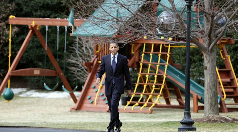 U.S. President Barack Obama walks past a new swing set as he departs the White House for Marine One on March 6, 2009 in Washington, DC.