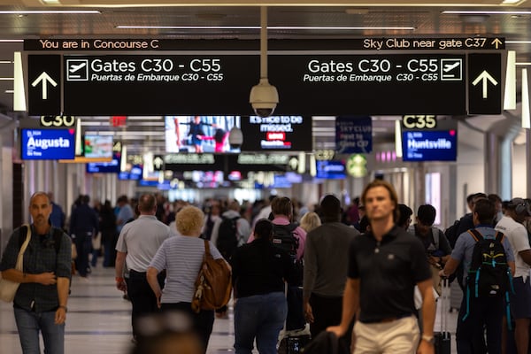 A traveler walks through Concourse C at Hartsfield-Jackson airport in Atlanta on June 4, 2025. (Arvin Temkar/AJC)