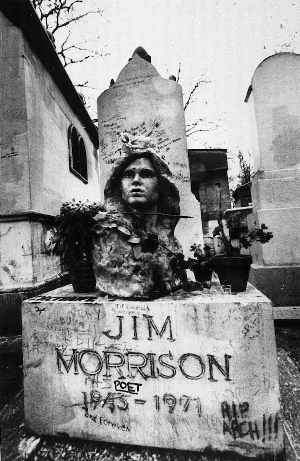 FILE- This Sept. 7, 1971 file photo shows the grave of Jim Morrison, lead singer of the rock group "The Doors," at the Pere Lachaise cemetery in Paris, France. (AP Photo/Joe Marquette,File)