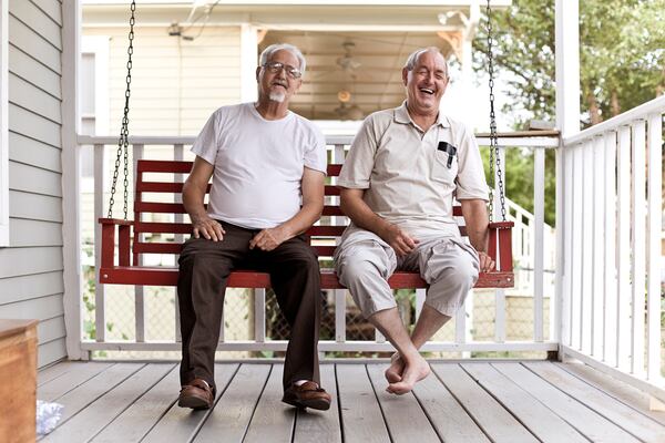 Ronnie (left) and Marshall Edwards on the porch swing of their Cabbagetown home in 2009. (Courtesy of Dane Sponberg)