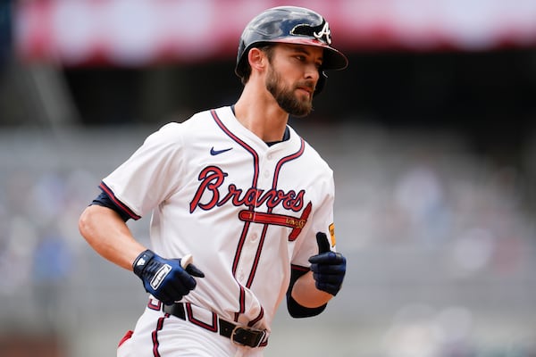 Braves outfielder Eli White rounds the bases after his decisive homer.