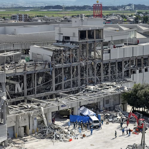In this aerial image taken with a drone, responders work outside AEON Mall Kumamoto after an explosion occurred following an earthquake, in Kashima, Kumamoto Prefecture, southern Japan, Thursday, July 30, 2026. (Koji Harada/Kyodo News via AP)