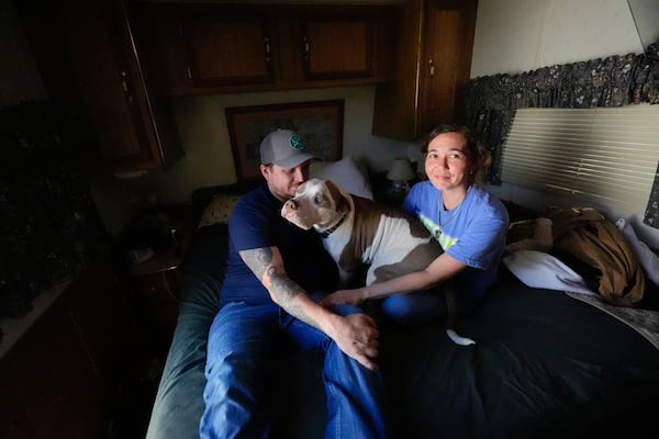 Michael Gibson and his fiancée Tabitha Enke sit inside their camper in Nahunta, Georgia, on Friday after two Enke family homes were destroyed Thursday during the Brantley Highway 82 fire. (Mike Stewart/AP)