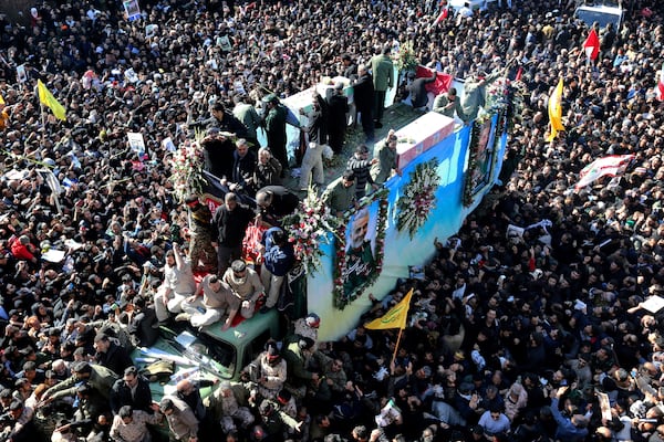 FILE - Coffins of Gen. Qassem Soleimani and others who were killed in Iraq by a U.S. drone strike, are carried on a truck surrounded by mourners during a funeral procession, in the city of Kerman, Iran, Jan. 7, 2020. (AP Photo, File)