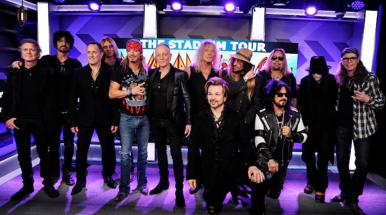 Musicians Rick Allen, from left, Tommy Lee, Vivian Campbell, Joe Elliott, Bret Michaels, Phil Collen, Rick Savage, Rikki Rokkett (kneeling), C.C. DeVille, Nikki Sixx (kneeling), Vince Neil, Mick Mars and Bobby Dall announced "The Stadium Tour" in December 2019. (Photo by Chris Pizzello/Invision/AP)