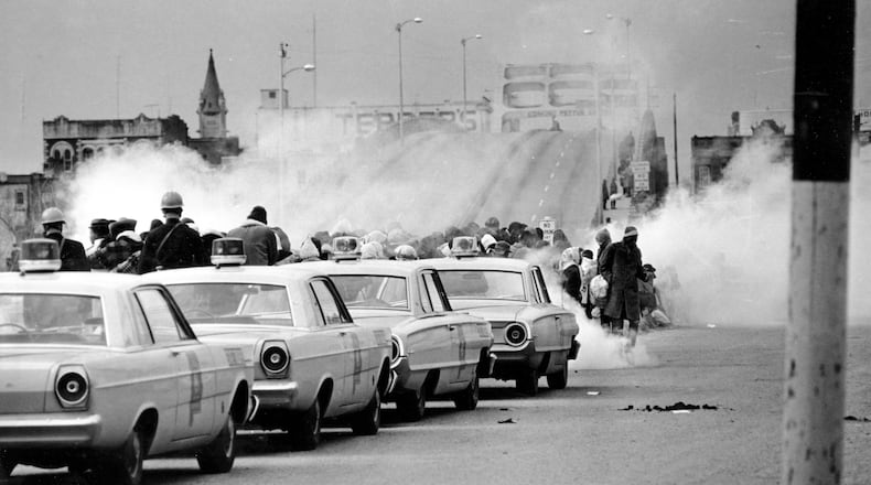 March 7, 1965: clouds of tear gas fill the air as state troopers, ordered by Gov. George Wallace, break up a demonstration march in Selma, Ala., on what became known as "Bloody Sunday." The Journal and Constitution chose not to send staff reporters to cover some of the biggest stories of the civil rights movement, including this one. (AP Photo/File)