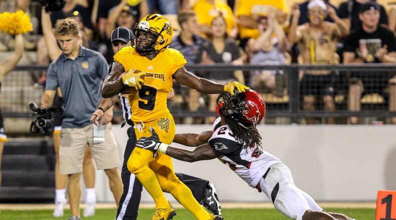 Kennesaw State running back Shaq Terry stiff arms a Clark Atlanta football player during a game on Sept. 22, 2018 at Fifth Third Bank Stadium