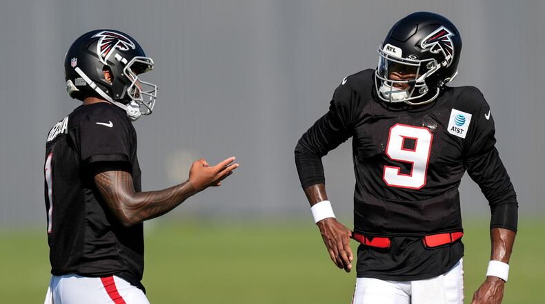 Atlanta Falcons quarterback Michael Penix Jr. (9) and Tua Tagovailoa speak during a Atlanta Falcons training camp, Monday, Aug. 3, 2026, in Flowery Branch, Ga. (AP Photo/Mike Stewart)