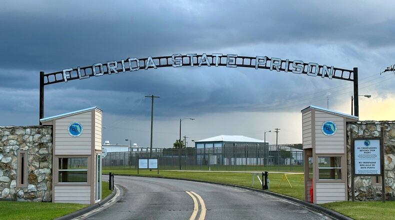 FILE - Clouds hover over the entrance of the Florida State Prison in Starke, Fla., Aug. 3, 2023. (AP Photo/Curt Anderson, File)