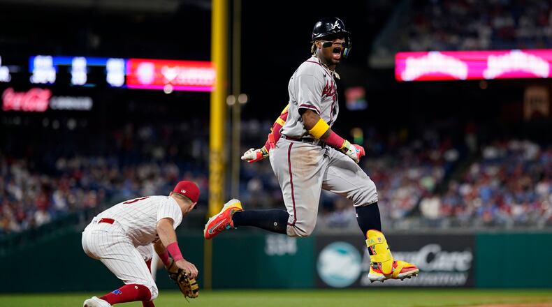 Atlanta Braves' Ronald Acuna Jr., right, reacts after beating the throw for a single past Philadelphia Phillies first baseman Kody Clemens during the ninth inning of a baseball game, Tuesday, June 20, 2023, in Philadelphia. (AP Photo/Matt Slocum)