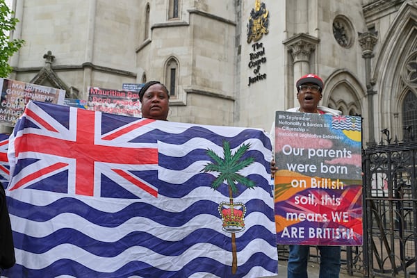 People demonstrate outside the High Court in London, Thursday, May 22, 2025, after a British court blocked the U.K. from transferring sovereignty over the Chagos Islands to Mauritius hours before the agreement was due to be signed. (AP Photo/Thomas Krych)