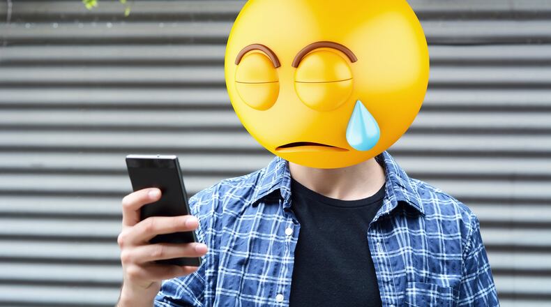 Emoji head man using a smartphone. (Dreamstime/TNS)
