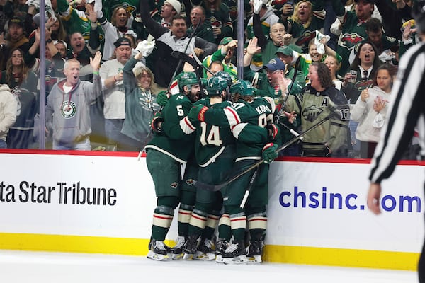 Minnesota Wild players celebrate after defenseman Jared Spurgeon scored a goal against the Vegas Golden Knights during the third period in Game 4 of an NHL hockey Stanley Cup first-round playoff series, Saturday, April 26, 2025, in St. Paul, Minn. (AP Photo/Stacy Bengs)