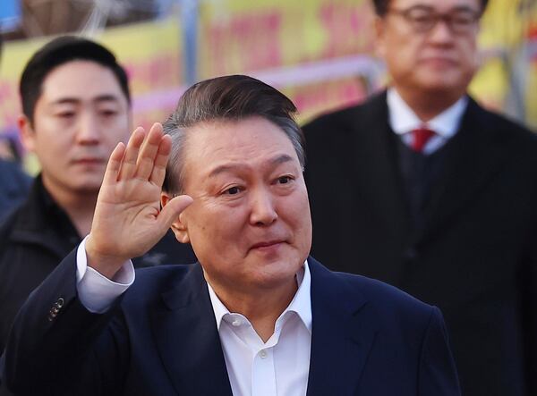 FILE - Impeached South Korean President Yoon Suk Yeol greets his supporters as he comes out of a detention center in Uiwang, South Korea, on March 8, 2025. (Kim Do-hun/Yonhap via AP, File)