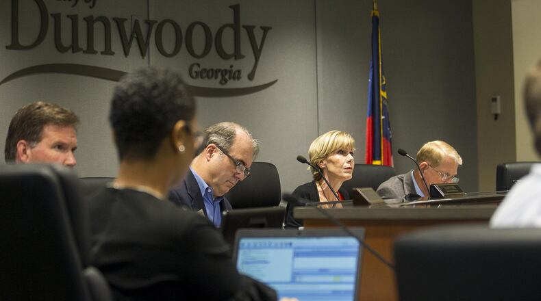 Members of the Dunwoody City Council listen to citizens during a meeting Monday. (Alyssa Pointer/alyssa.pointer@ajc.com)