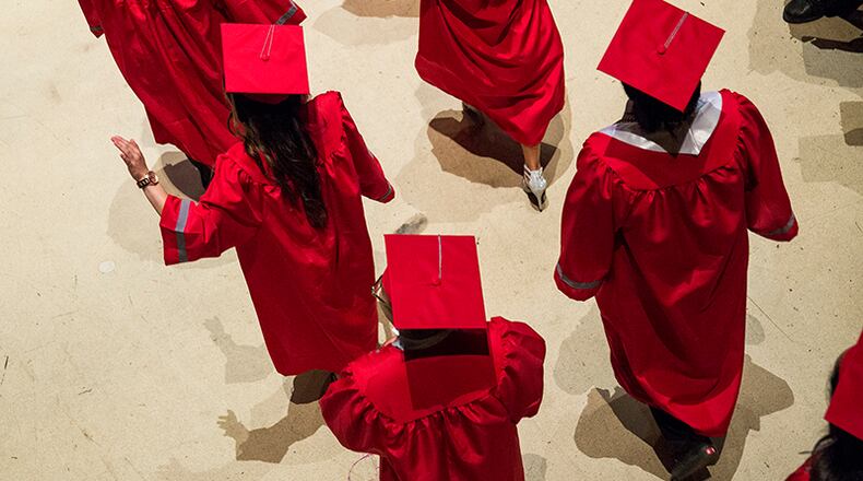 Graduates enter the arena during Travis Prep Academy and Travis High School's commencement ceremony at the Erwin Center in Austin on Thursday, June 1, 2017. NICK WAGNER/AMERICAN-STATESMAN