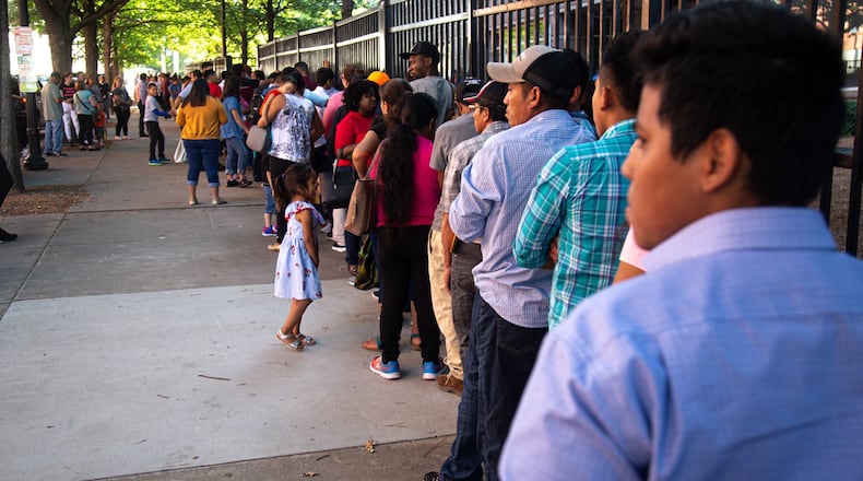 Long lines form outside the Atlanta Immigration Court in 2019. STEVE SCHAEFER / SPECIAL TO THE AJC