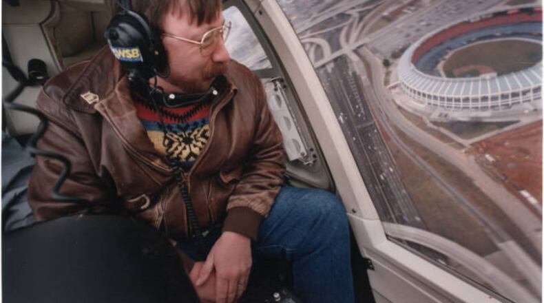 Traffic reporter, Herb Emory, from WSB Radio, giving a traffic report from a helicopter. Atlanta-Fulton County Stadium sits in the background, Atlanta, Georgia, January 3, 1994. AJC FILE PHOTO