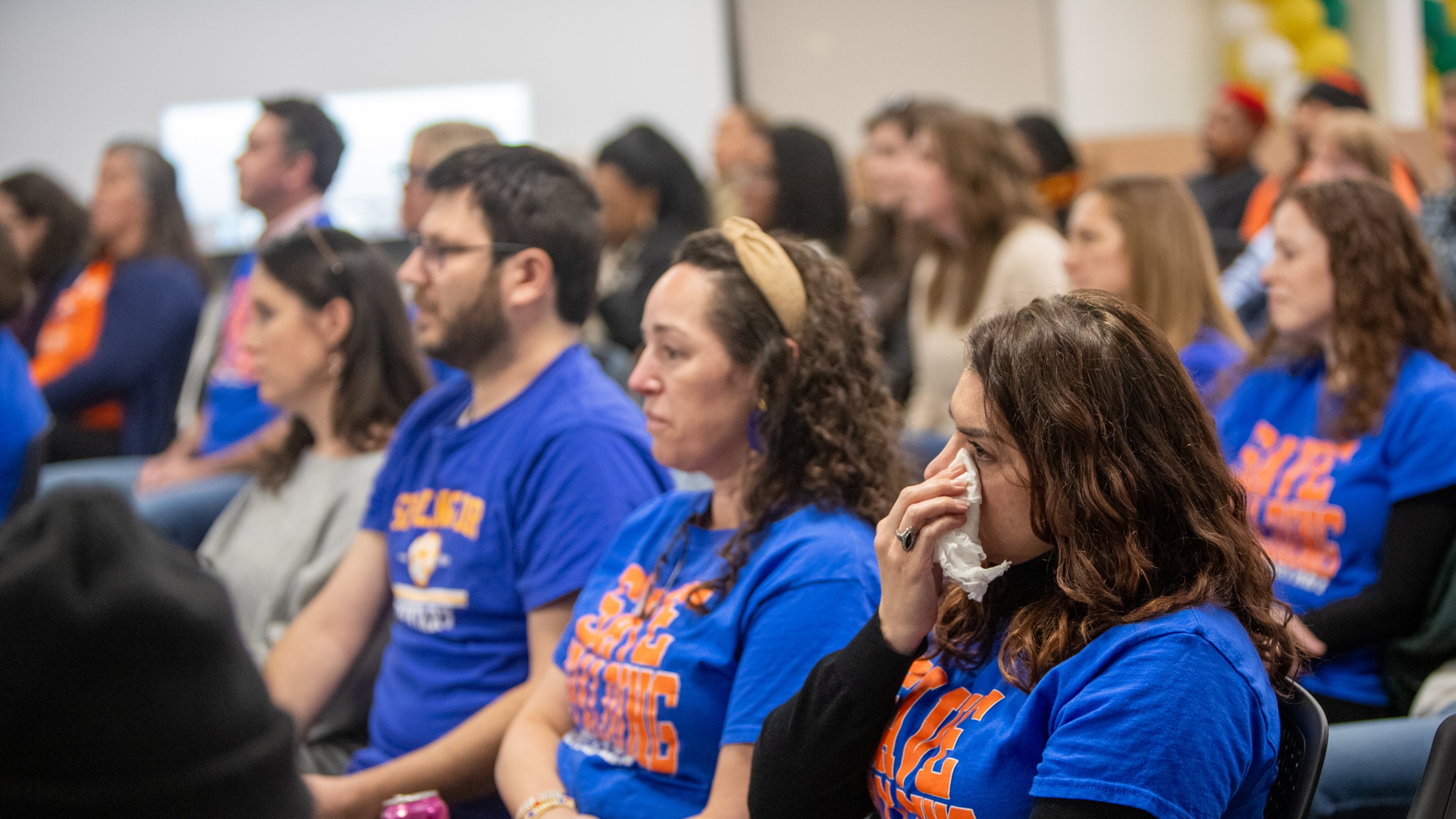 Spalding Drive Elementary School mother Michelle Schiessle sits at the Fulton County Board of Education meeting on Feb. 20, where the board voted to close that school, as well as Parklane Elementary School in East Point, at the end of the 2024-25 school year. (Jenni Girtman for the AJC)