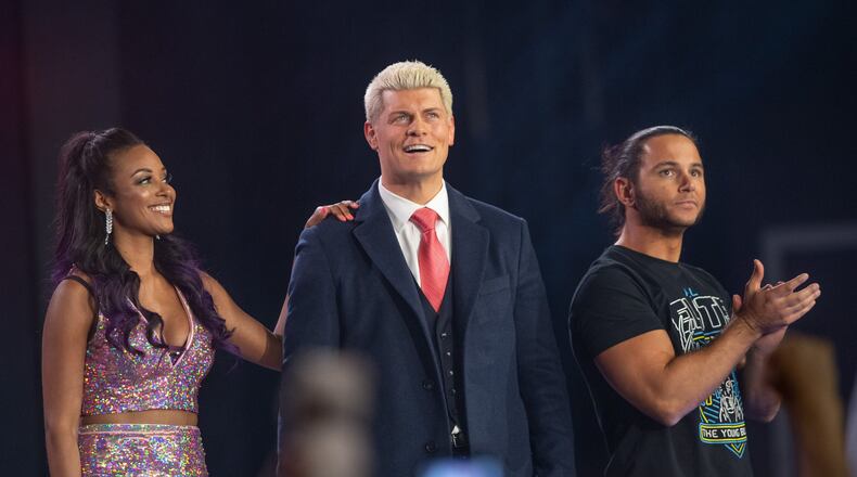 All Elite Wrestling’s executive vice president Cody Rhodes, center, and chief brand officer Brandi Rhodes, left, stand beside one half of tag team titans the Young Bucks, who were instrumental in creating AEW. (Tom Donoghue/Courtesy of AEW)